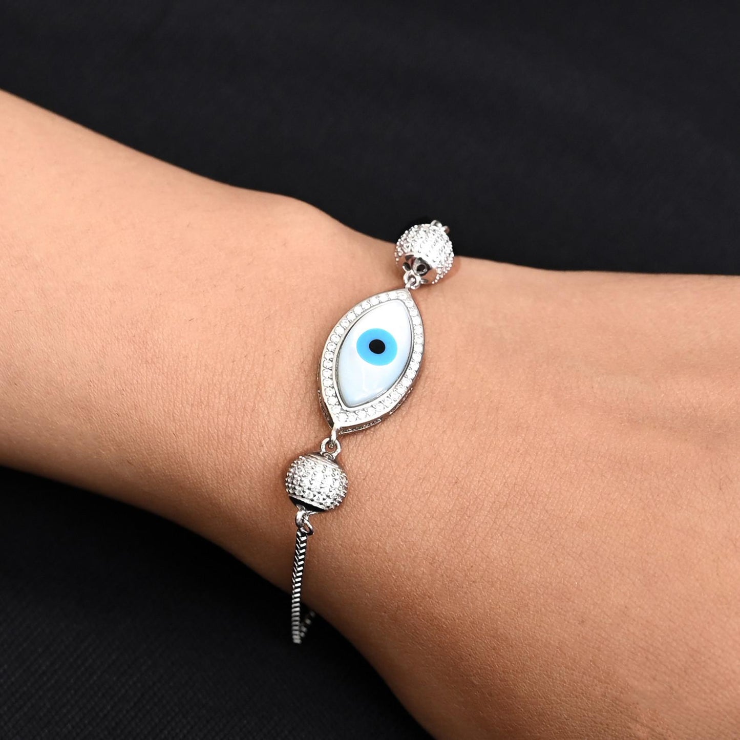 Silver bracelet featuring smash beads and a protective evil eye charm