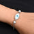 Silver bracelet featuring smash beads and a protective evil eye charm