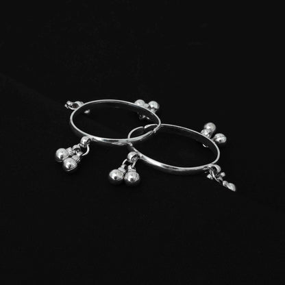 Charming silver baby kada adorned with ghungroos and a sleek plain design