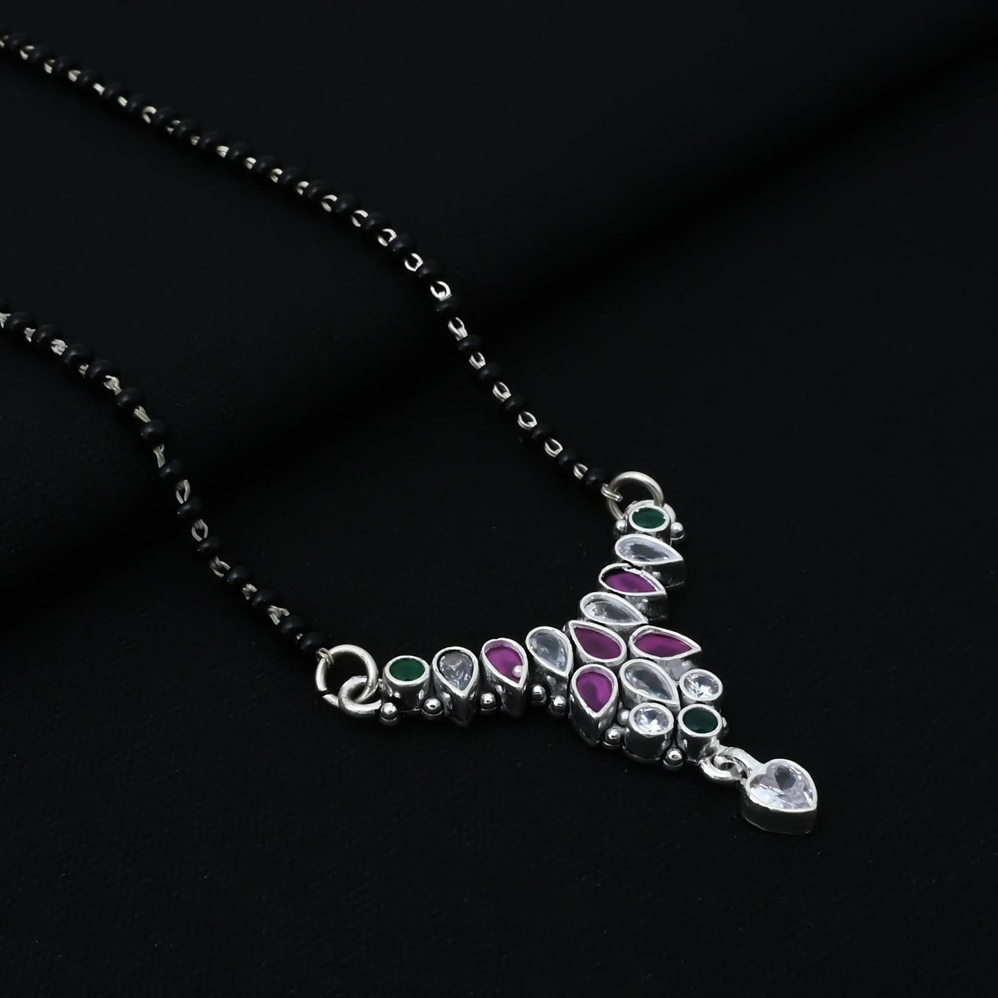 Timeless silver mangalsutra adorned with multi-colored gemstones, showcasing a vintage charm