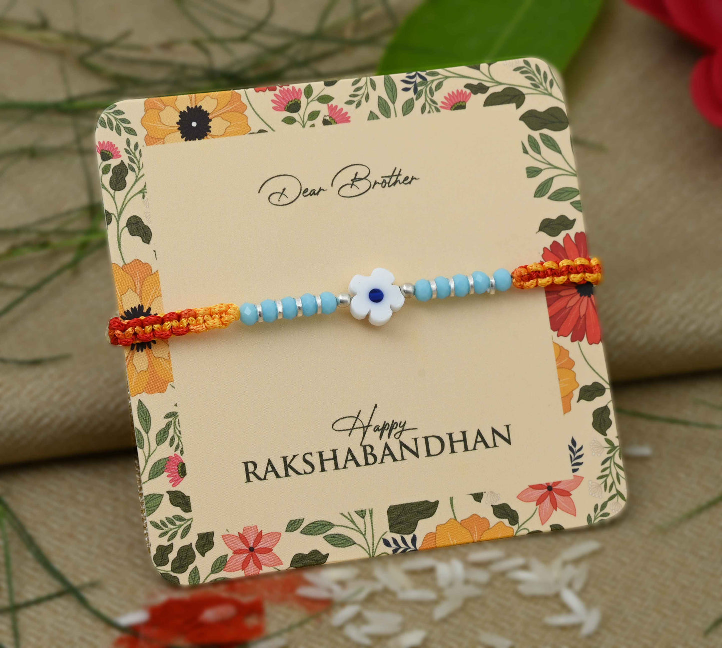 Silver center light blue flower design with silver and light blue beads, perfect Rakhi for boys.