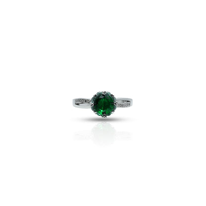 Silver ring with green gemstone and infinity flower design.