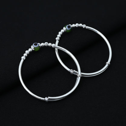 Charming silver baby kada with a beautiful green pearl for a timeless look