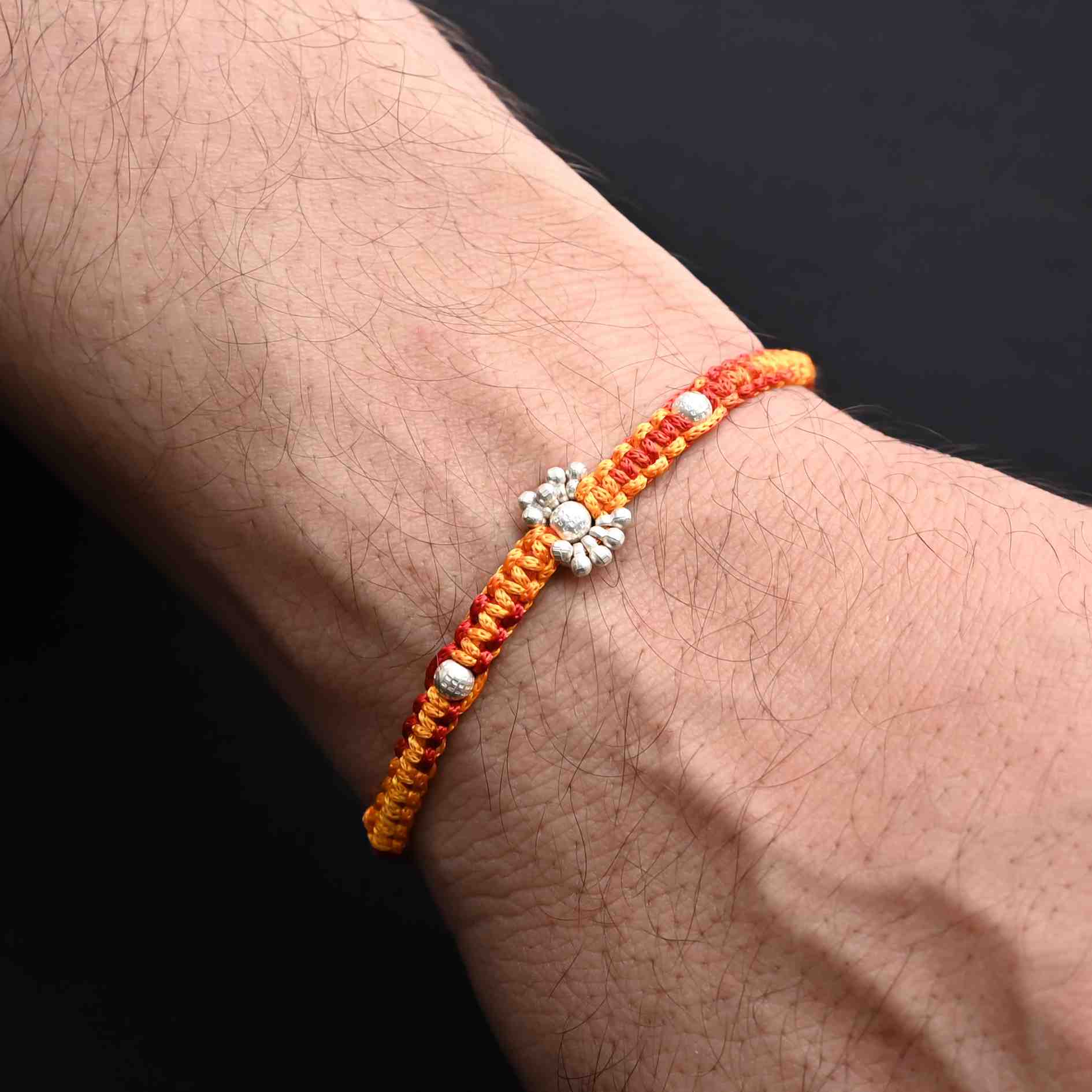 Boys' Rakhi featuring shimmering silver beads for a modern look