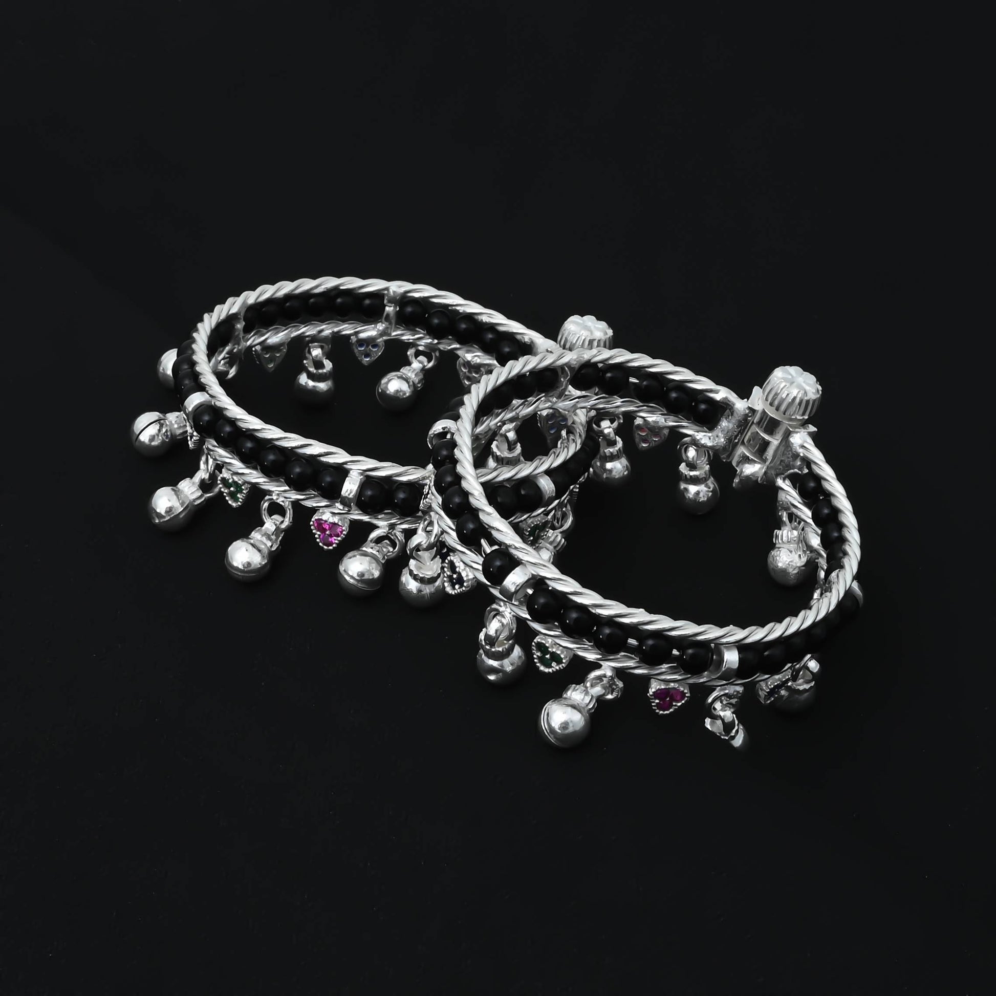 Stylish silver baby payal adorned with black beads for a trendy look