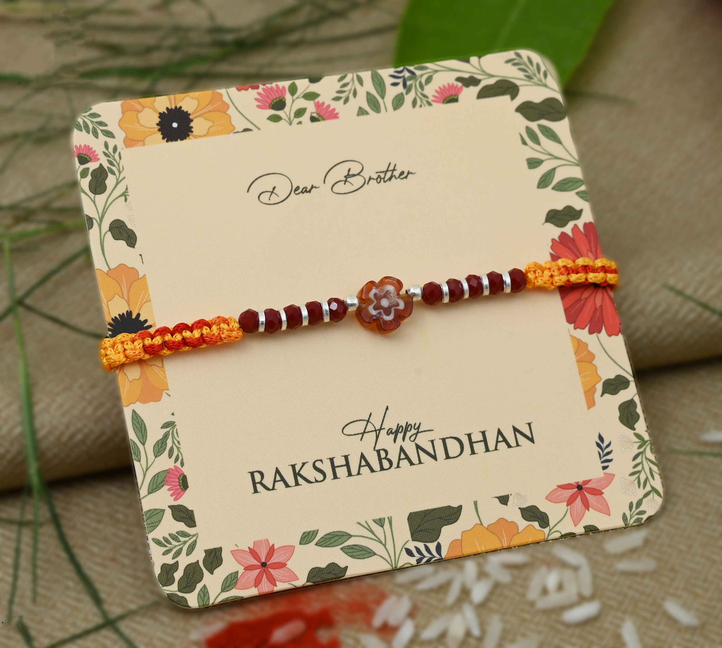 Silver center brown flower design with silver and light brown beads Rakhi for boys.