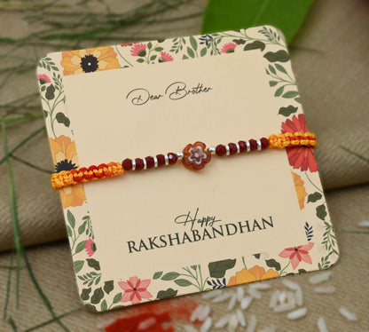 Silver center brown flower design with silver and light brown beads Rakhi for boys.