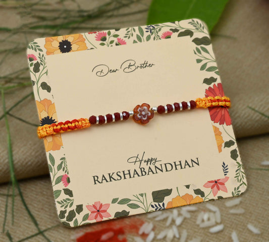 Silver center brown flower design with silver and light brown beads Rakhi for boys.