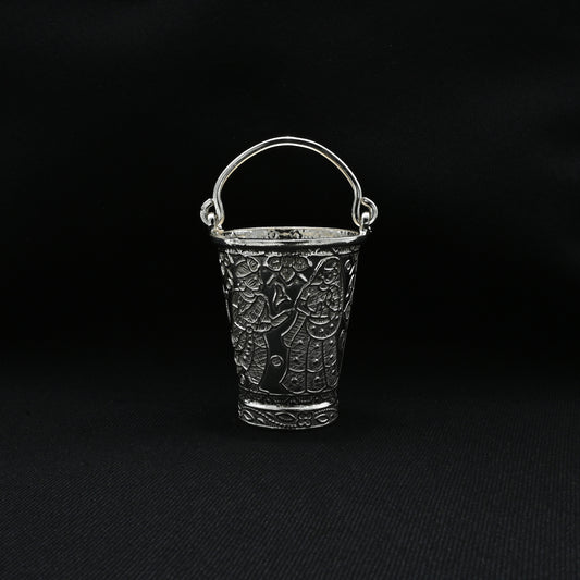 Traditional silver bucket adorned with a beautiful flower motif