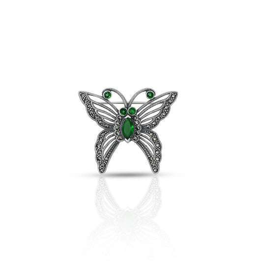 Silver saree pin with green stone butterfly design, adding a vibrant and elegant touch to your saree