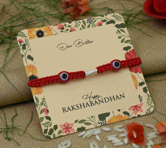 Silver Rakhi featuring two light purple evil eye charms, perfect for boys