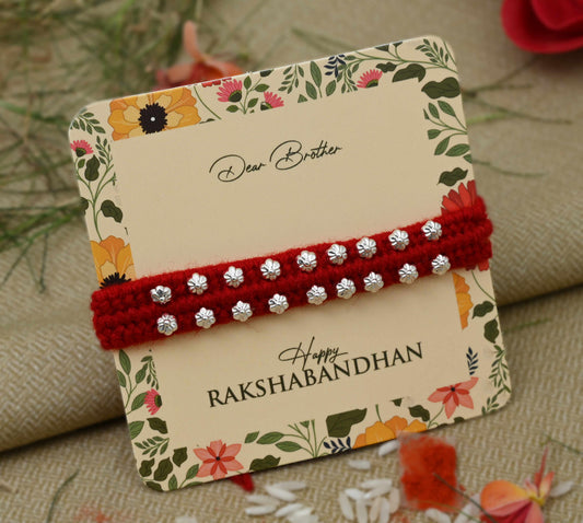 Silver Rakhi with multiple small flower design beads, perfect for boys.