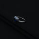 Charming silver ring adorned with blue heart motif.