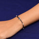 Trendy bracelet for girls featuring a blue evil eye charm, accented with black and silver beads.