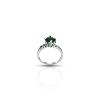 Elegant silver ring featuring green gem and floral infinity.