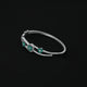 Stylish sterling silver kada bracelet adorned with green gemstones and 'Diva's Prestige' motif