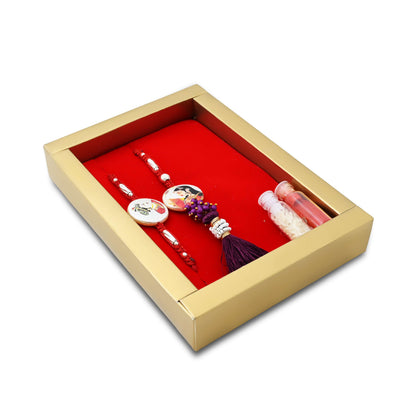 Silver Raja Rani Rakhi with a maroon theme, kumkum, and rice, perfect for boys.