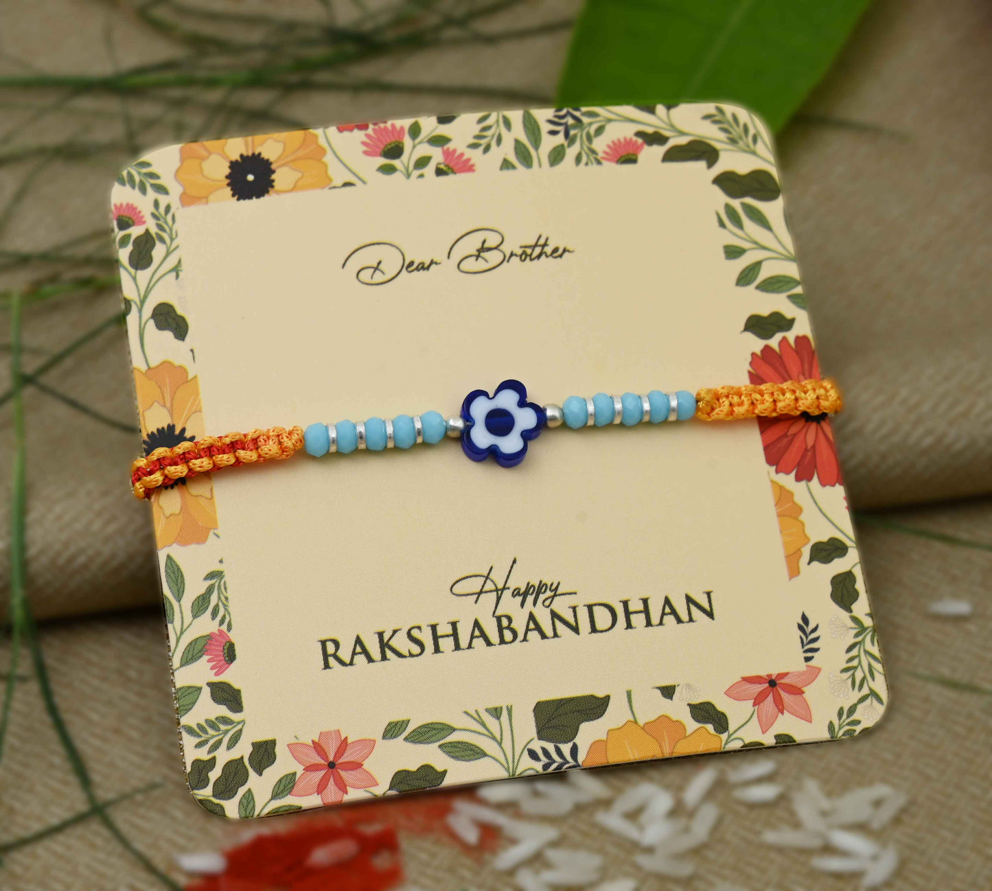 Silver center blue flower design with silver and light blue beads, perfect Rakhi for boys.