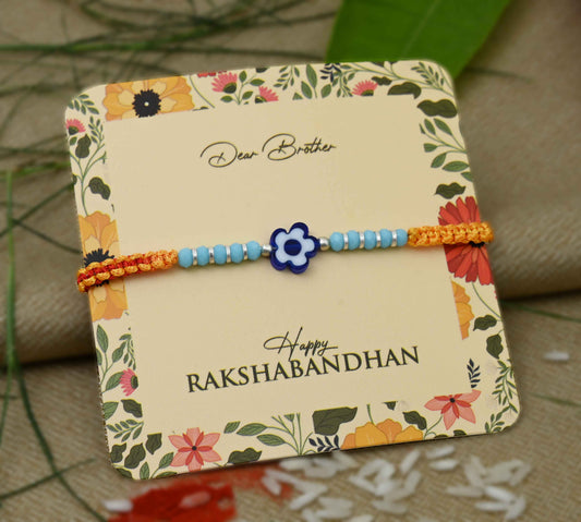 Silver center blue flower design with silver and light blue beads, perfect Rakhi for boys.