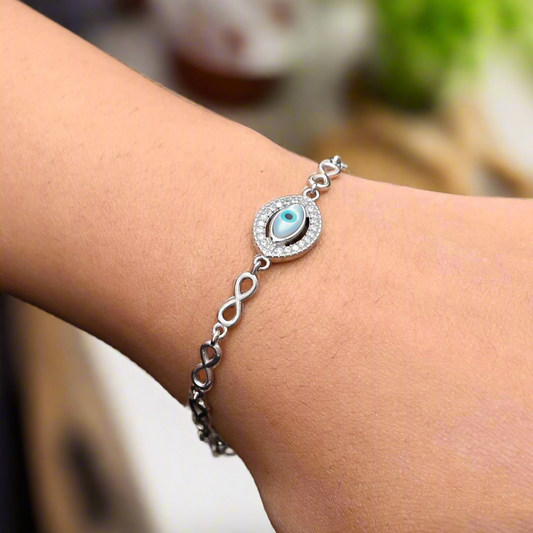 Sterling silver bracelet for girls featuring a protective evil eye and infinite design