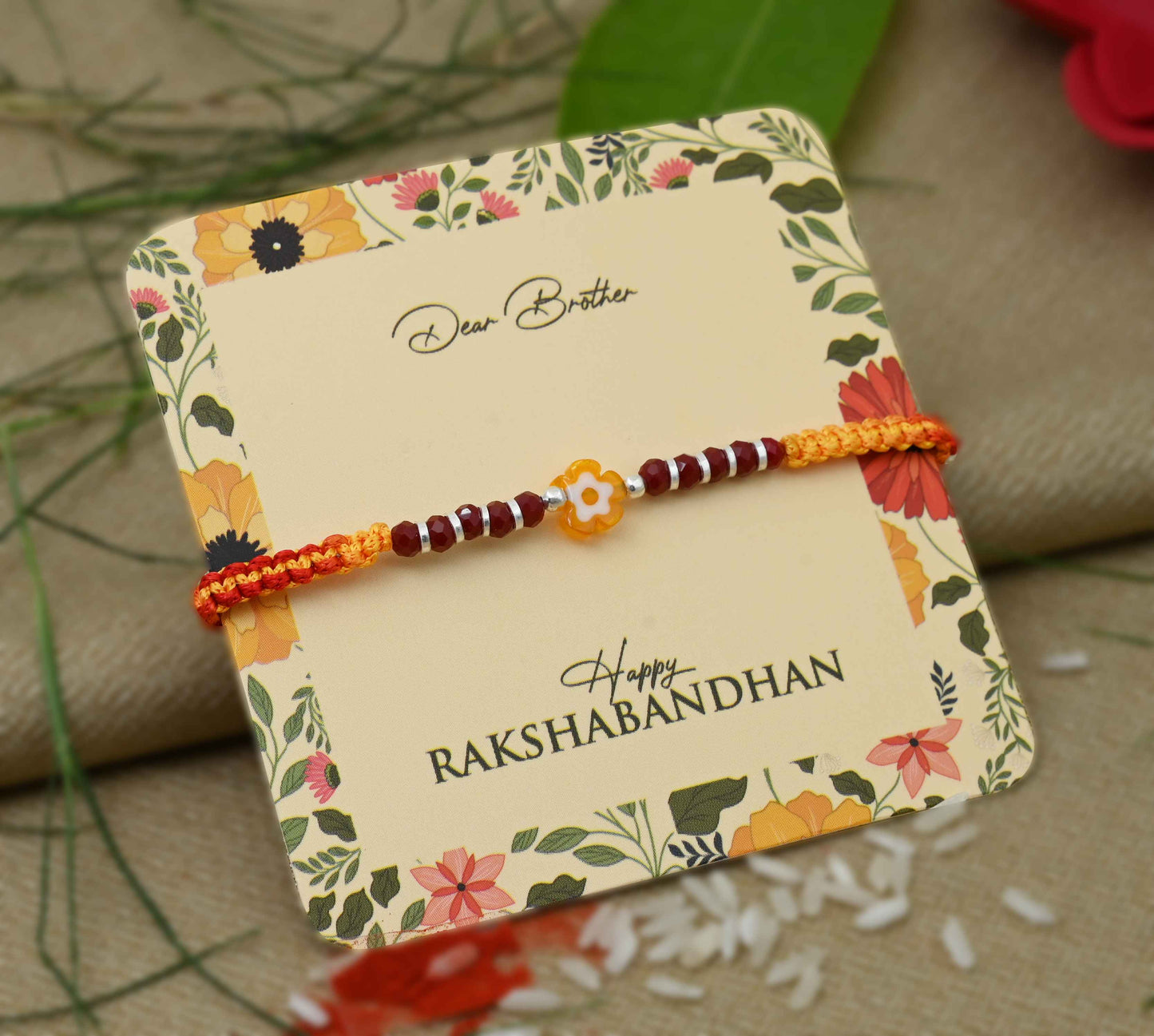 Silver center yellow flower design with silver and light red beads, perfect Rakhi for boys
