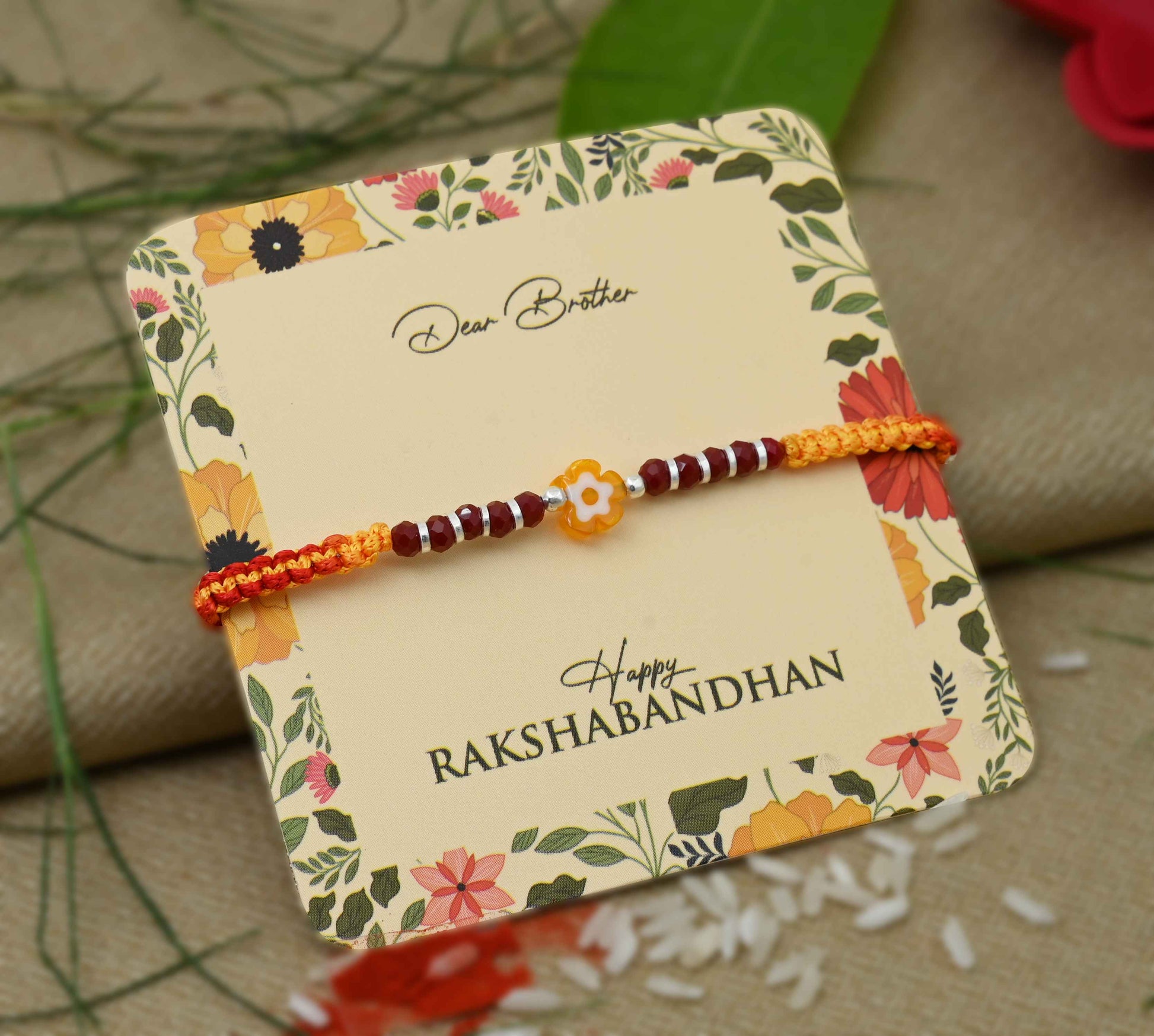 Silver center yellow flower design with silver and light red beads, perfect Rakhi for boys