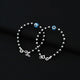 Elegant silver bracelet adorned with a light blue evil eye and black-silver bead accents