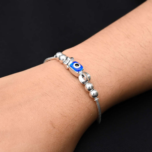 Sterling silver bracelet for girls featuring a single evil eye charm