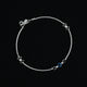 Charming silver anklet with a blue and black evil eye centerpiece, ideal for a trendy and symbolic addition to your look