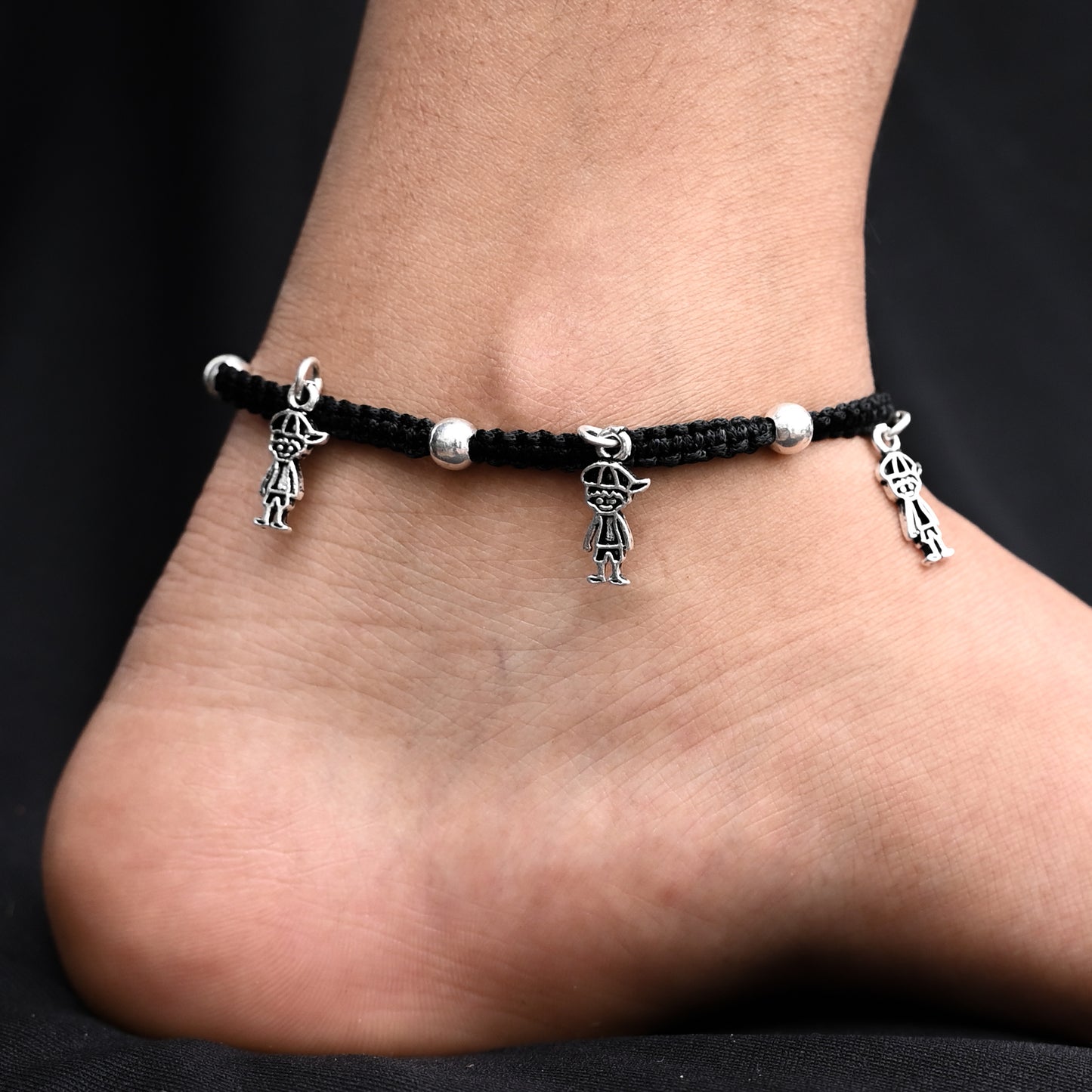 Stylish black thread anklet with oxidized silver 'Boy Charms' for her.