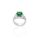 Close-up of a silver ring adorned with a shining green gemstone, perfect for adding a touch of luxury.