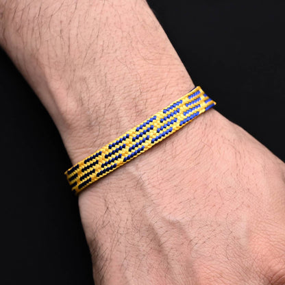 Chic silver bracelet with a vibrant blue and yellow knitted pattern, perfect for a bold look