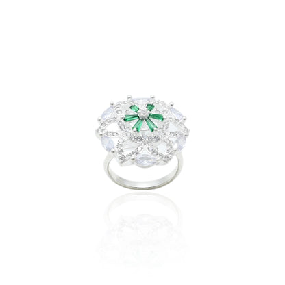 Close-up of a silver ring adorned with vibrant green and sparkling white stones, perfect for a sophisticated look.