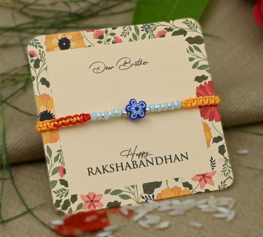Silver center blue flower design with silver and light blue beads Rakhi for boys.