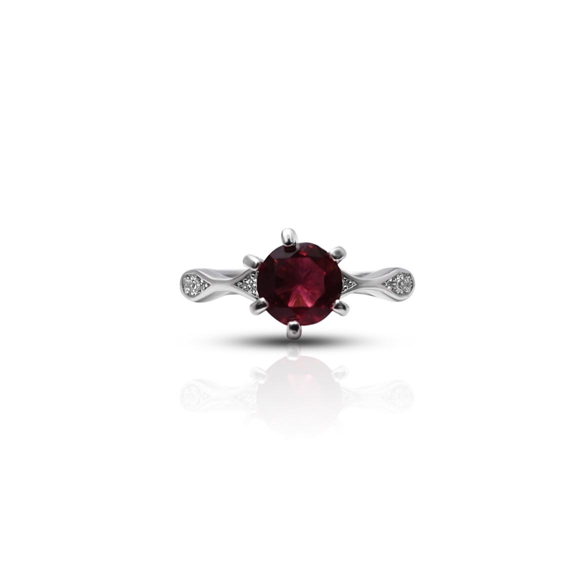 Close-up view of a sterling silver ring for girls, featuring a vibrant blood red gemstone at its center.