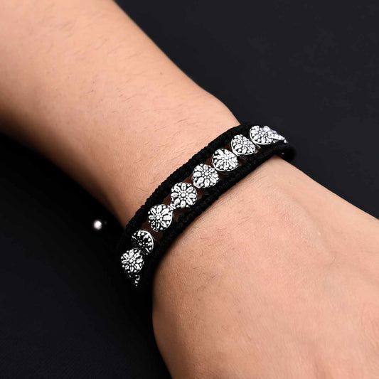 Men's silver bracelet featuring multiple flower designs for a bold look