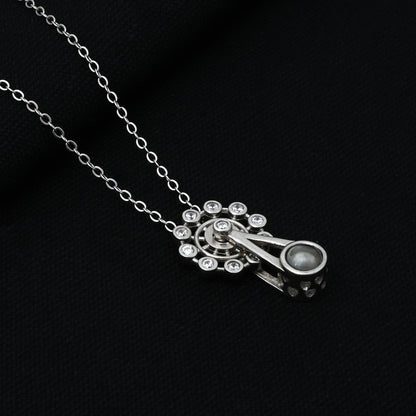 Close-up of the pendulum design pendant on a silver chain