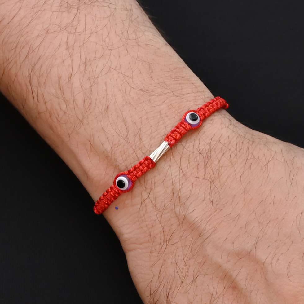 Elegant Rakhi with two light purple evil eyes in silver, ideal for boys